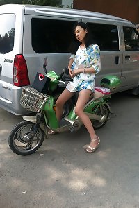 asian cougar riding a scooter